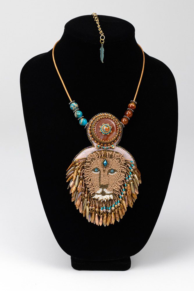 A necklace with a lion head on it