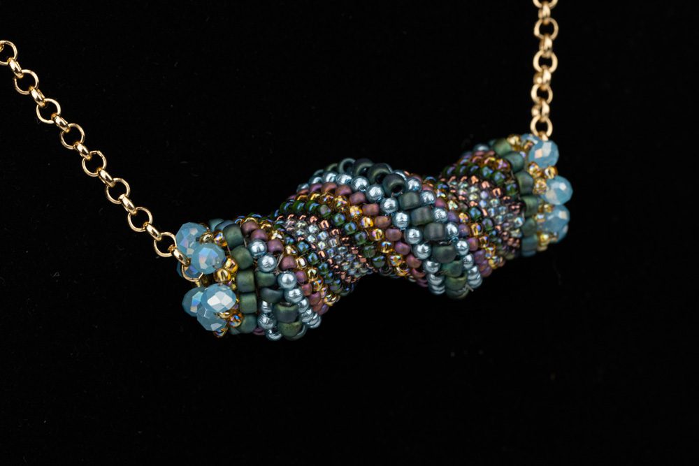 A close up of the bead work on a necklace