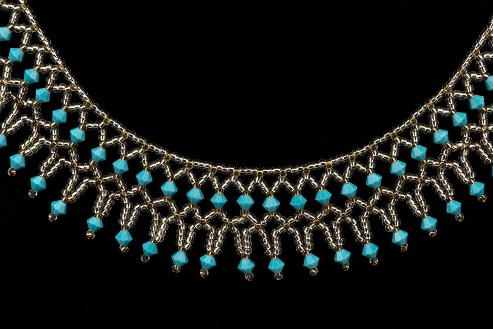 A necklace with blue beads and silver chain.