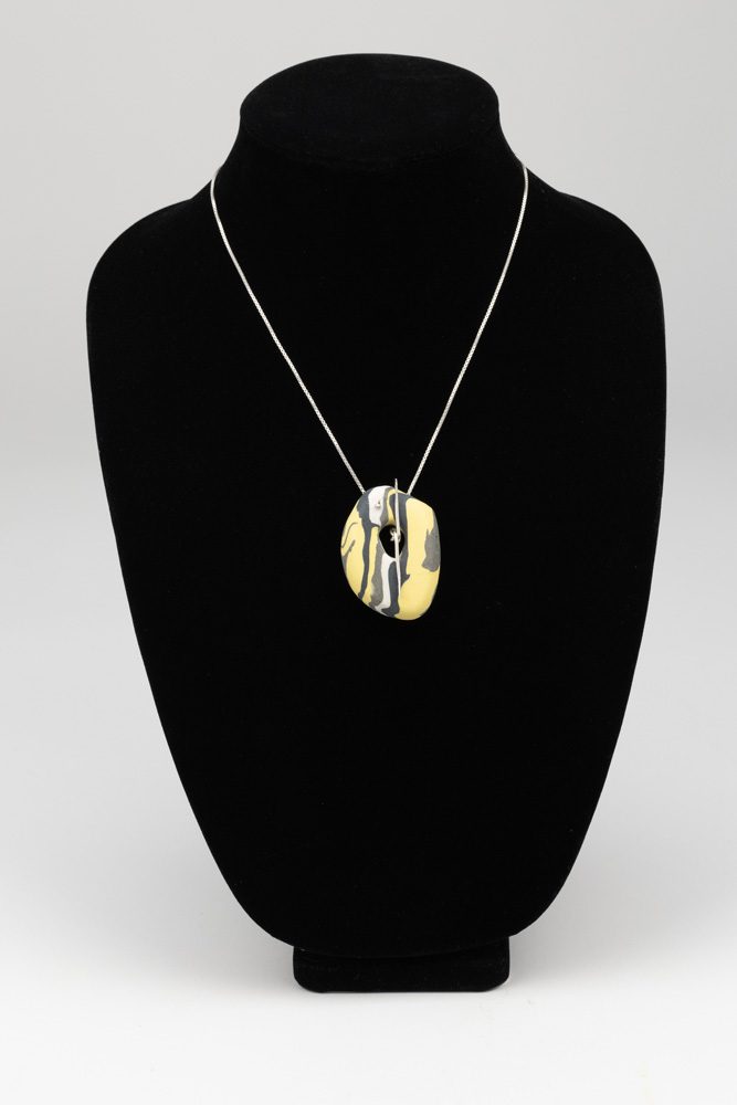 A necklace is shown on display in a black case.