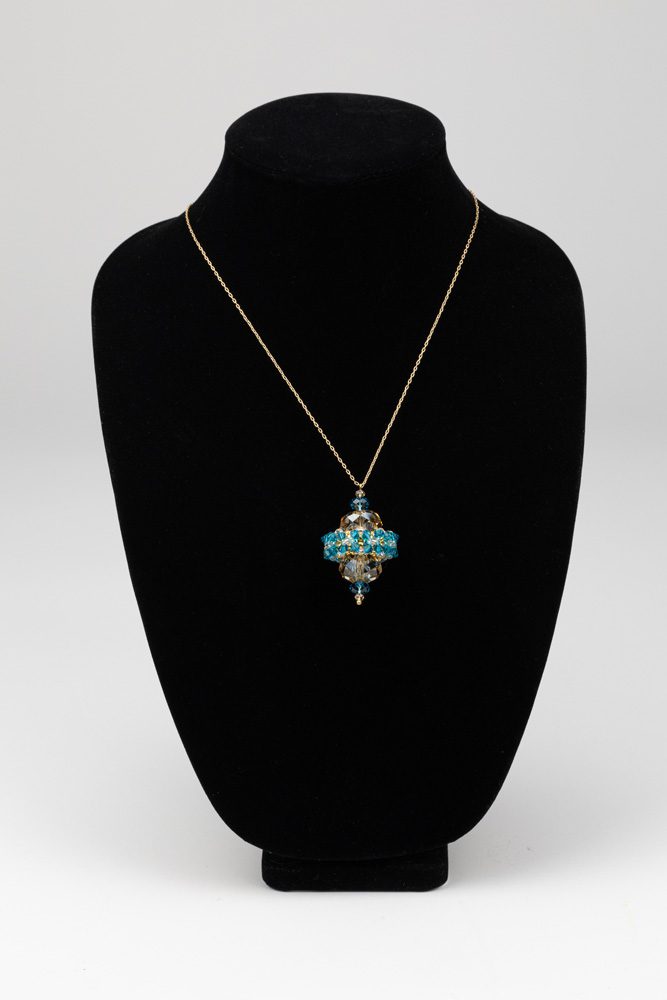 A necklace is shown on display in front of a black background.