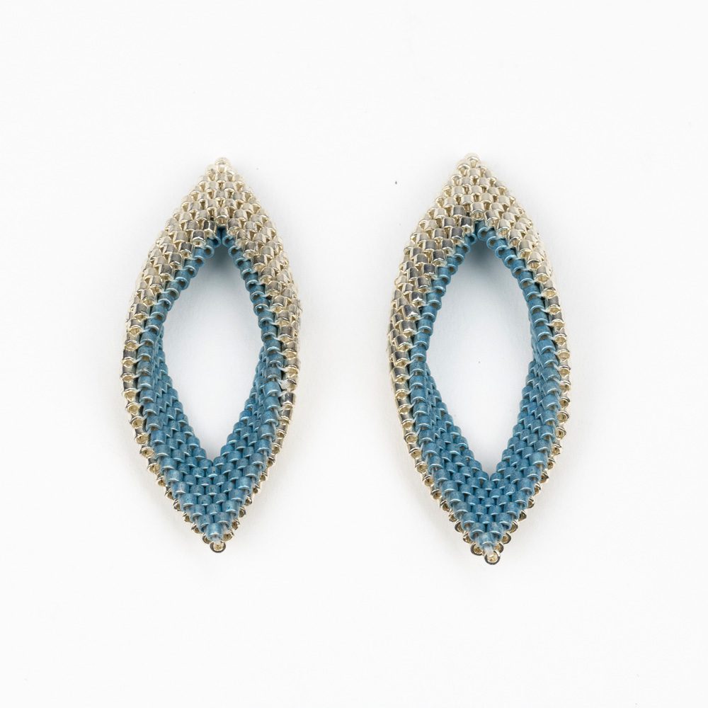 A pair of earrings made from beads and metal.