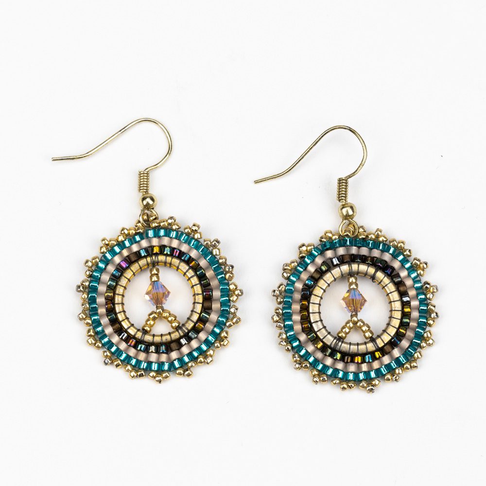 A pair of earrings with beads and metal.