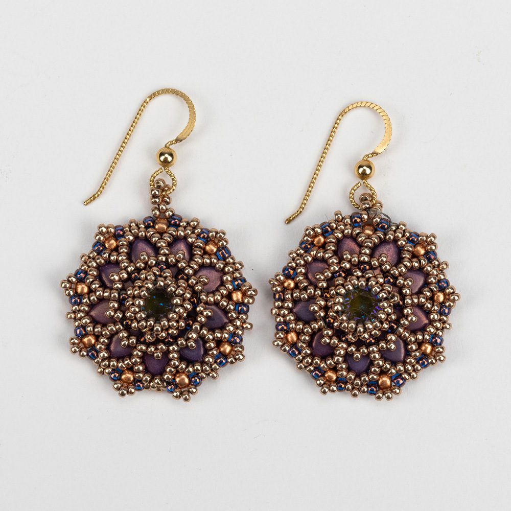 A pair of earrings with beads and gold wire.