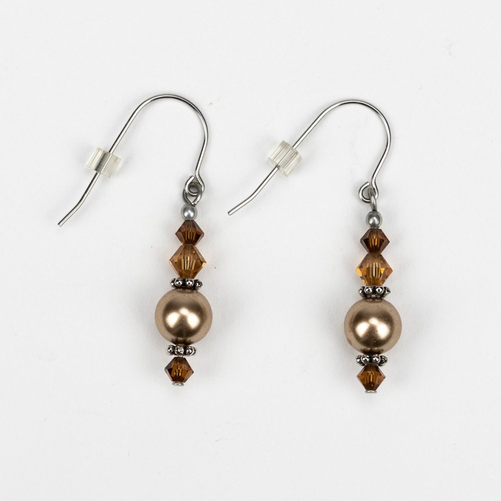 A pair of earrings with brown beads and silver accents.