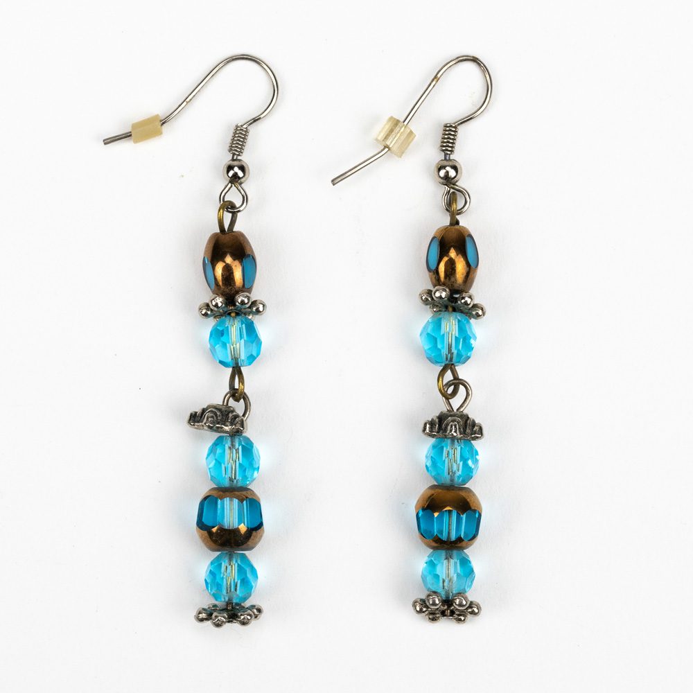 A pair of earrings with blue beads and metal accents.