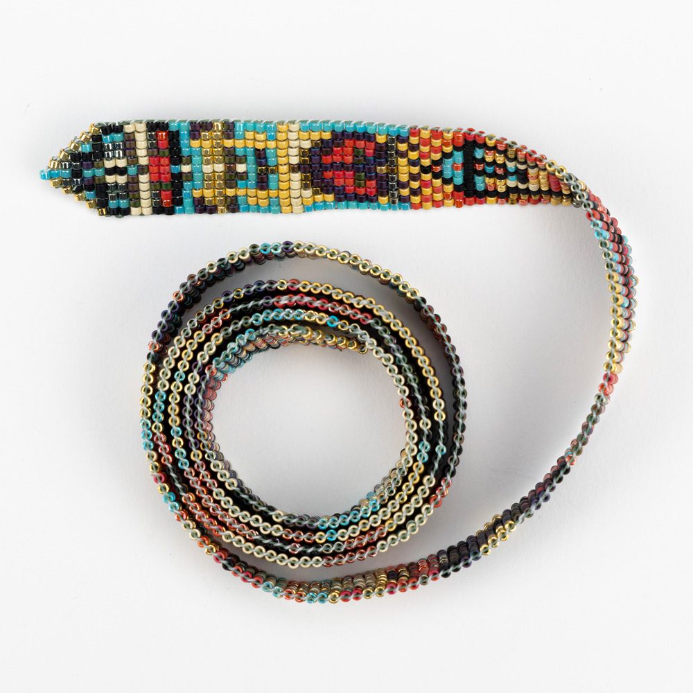 A colorful beaded tie is shown on a white background.