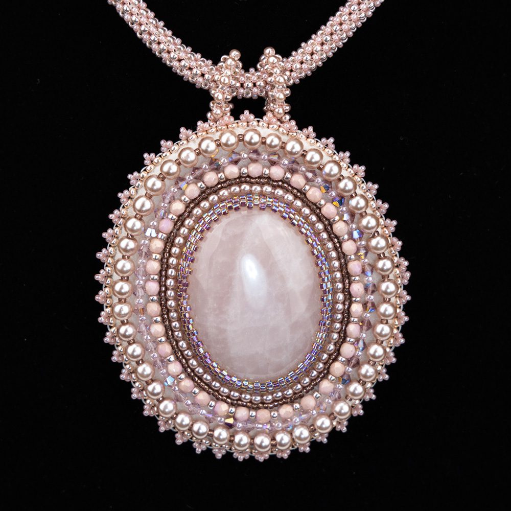 A necklace with a large white stone on it.